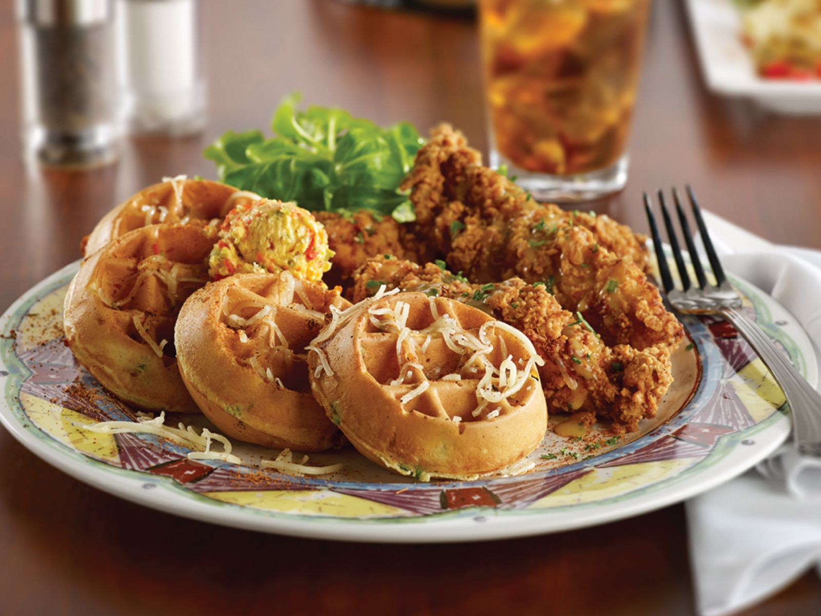 Visit Miss Shirley's Cafe for a delectable dish of fried chicken and waffles served on a plate. You'll love the delightful flavors and the convenient parking available.