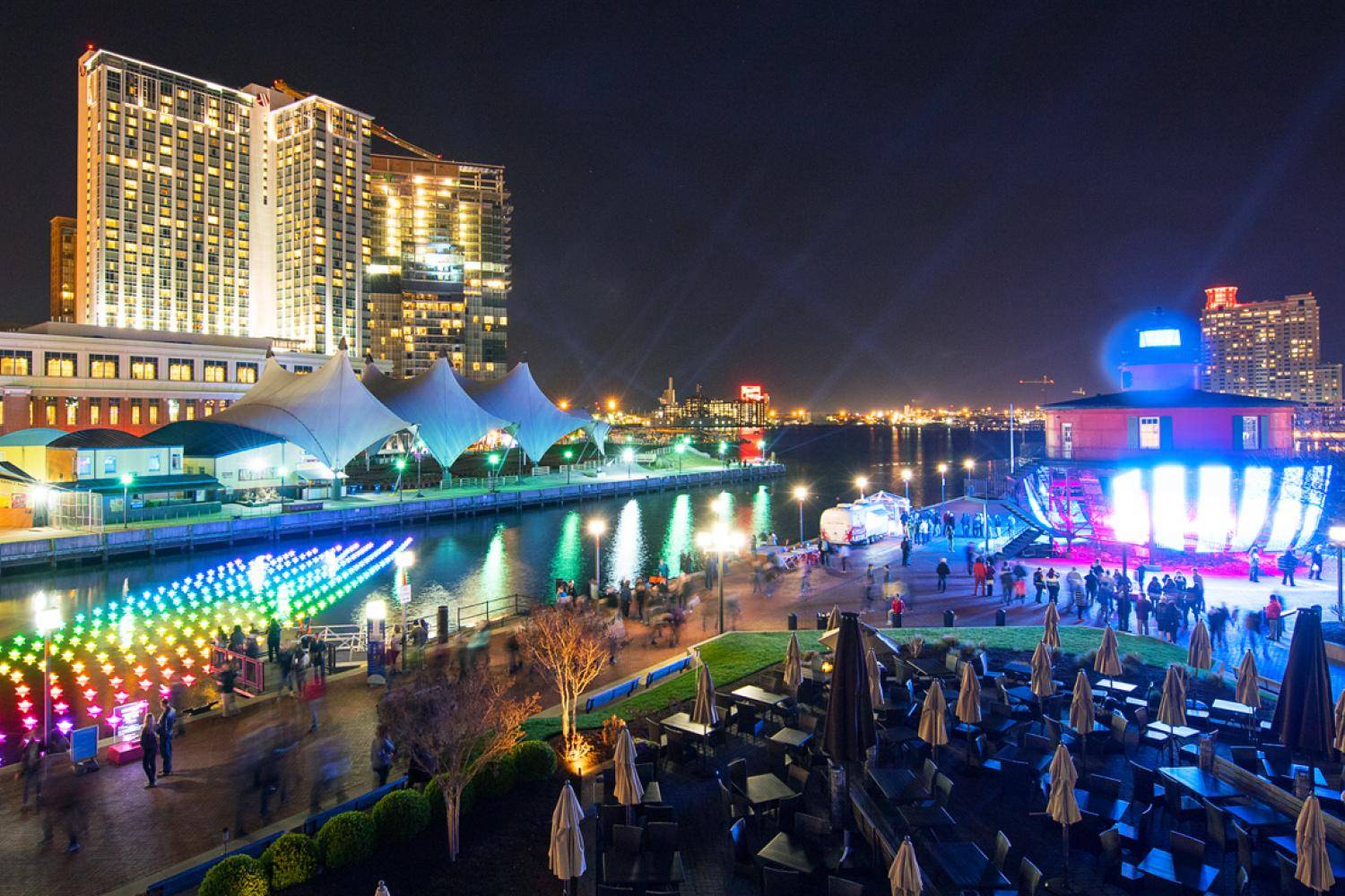 A view of a city at night with a river in the background.