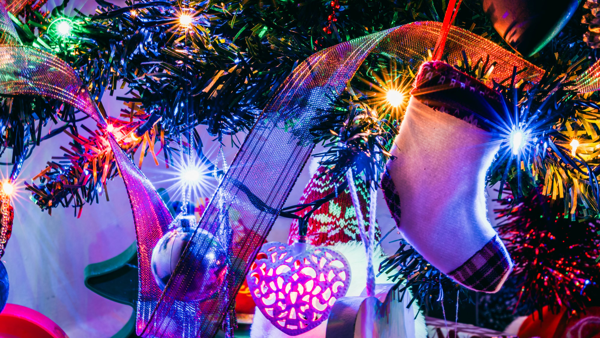 A christmas tree decorated with lights and ornaments at Power Plant Live, a festive location that hosts the 12 Bars of Charity event.